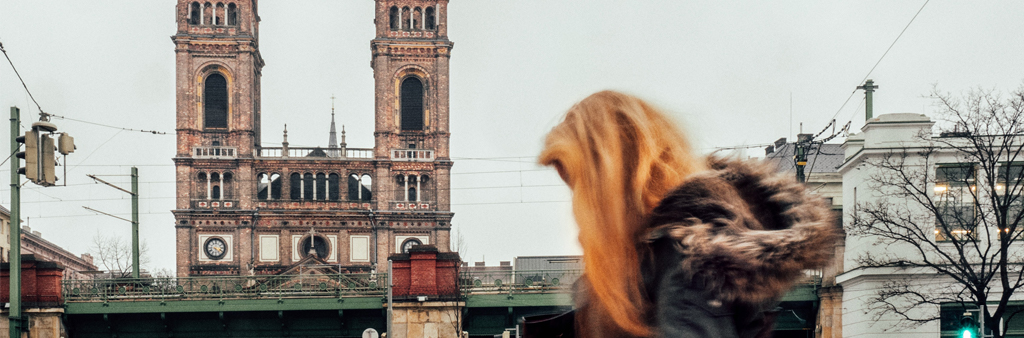 Woman In Coat Walking In Street