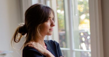 Woman Smiling Looking Out The Window