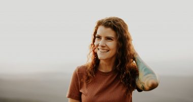 Woman In Brown Crewneck T-shirt Smiling