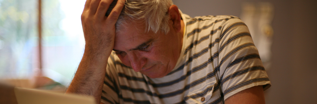 Elderly Man Resting Head On Hand