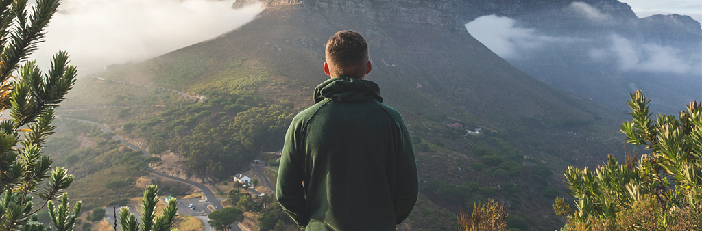 Man In Green Sweatshirt Looking At Mountain