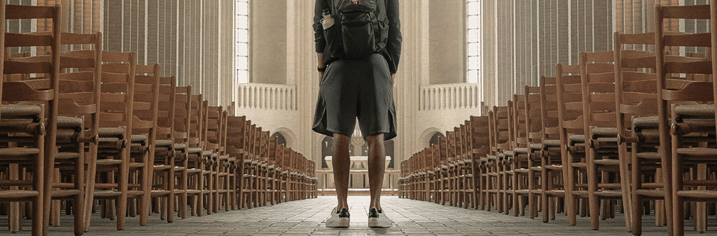 Man In Shorts And Tennis Shoes Standing In The Middle Of Chairs