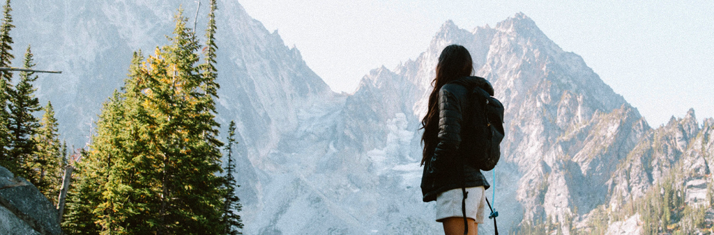 Woman With Black Backpack Looking At Mountain During The Day