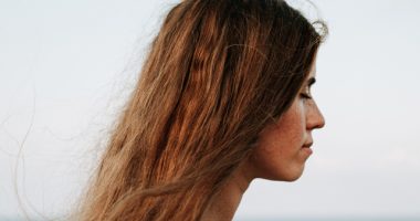 Woman With Long Brown Hair Closing Eyes